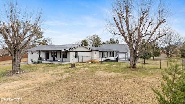 rear view of house with a garage, a lawn, and a porch