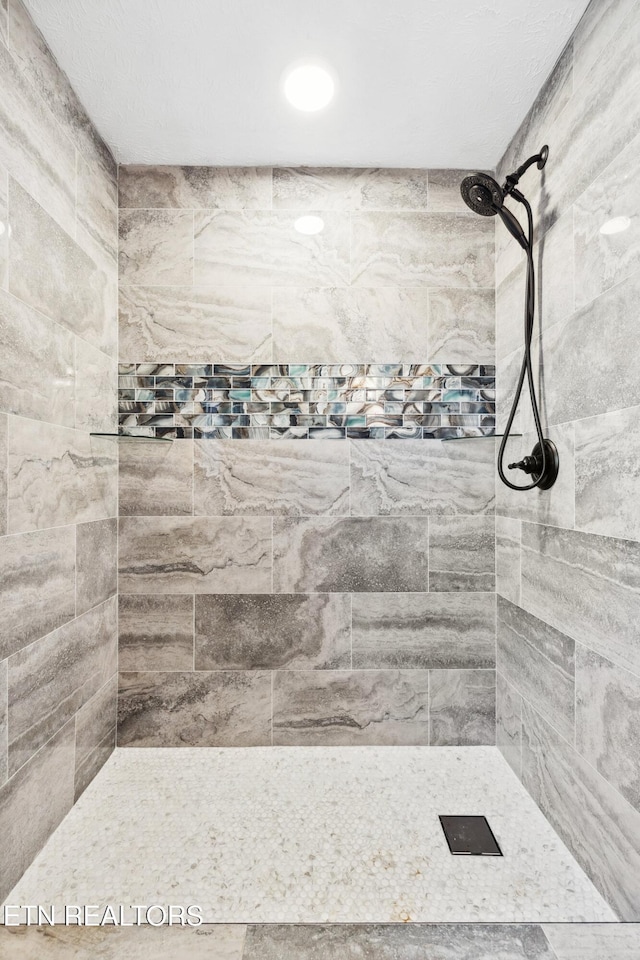 bathroom with tiled shower