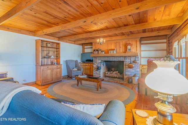 living room featuring wood ceiling, beam ceiling, a brick fireplace, and light wood-type flooring