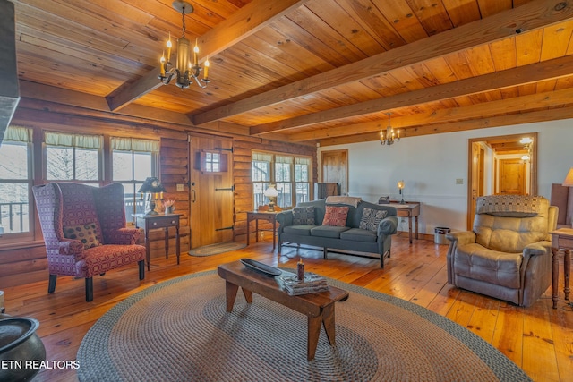 living room featuring beamed ceiling, light wood-type flooring, wooden ceiling, and an inviting chandelier