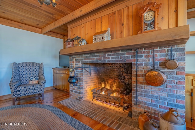 room details with beamed ceiling, wood ceiling, wood-type flooring, and a fireplace