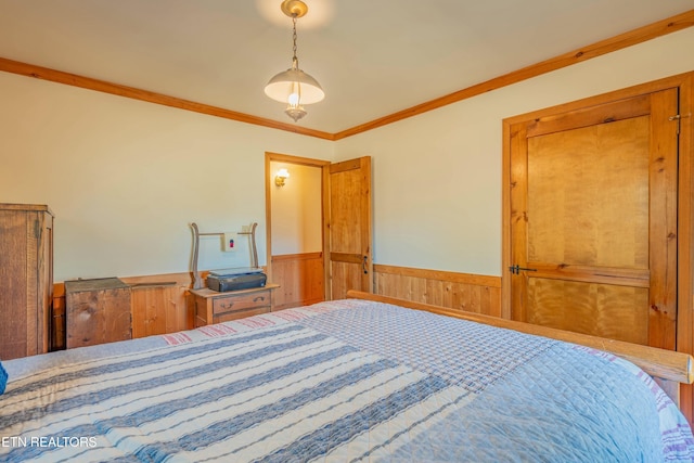 bedroom featuring wooden walls and ornamental molding