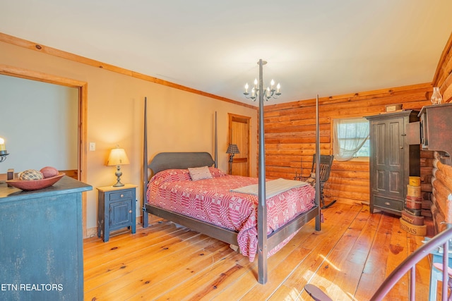 bedroom with a notable chandelier, crown molding, rustic walls, and light wood-type flooring