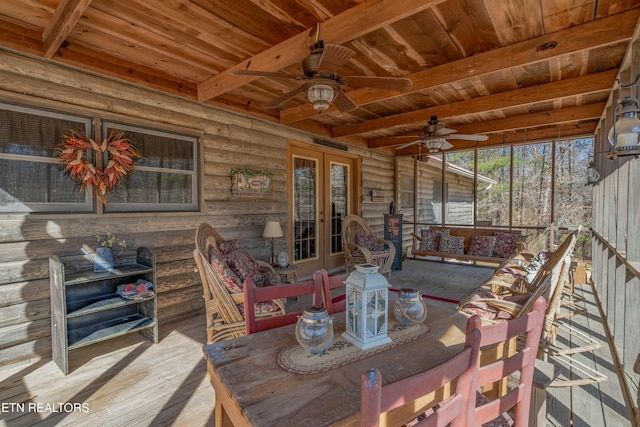 interior space with wood-type flooring, log walls, ceiling fan, wooden ceiling, and beam ceiling