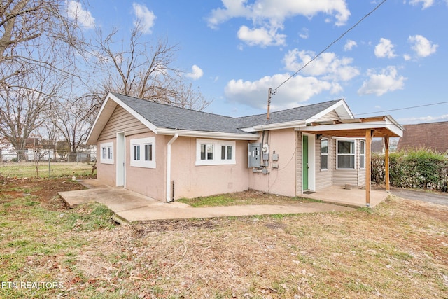 back of property with a patio and a lawn