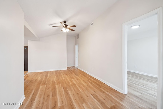 unfurnished room with vaulted ceiling, ceiling fan, and light hardwood / wood-style floors