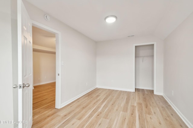 unfurnished bedroom with light hardwood / wood-style floors and a closet