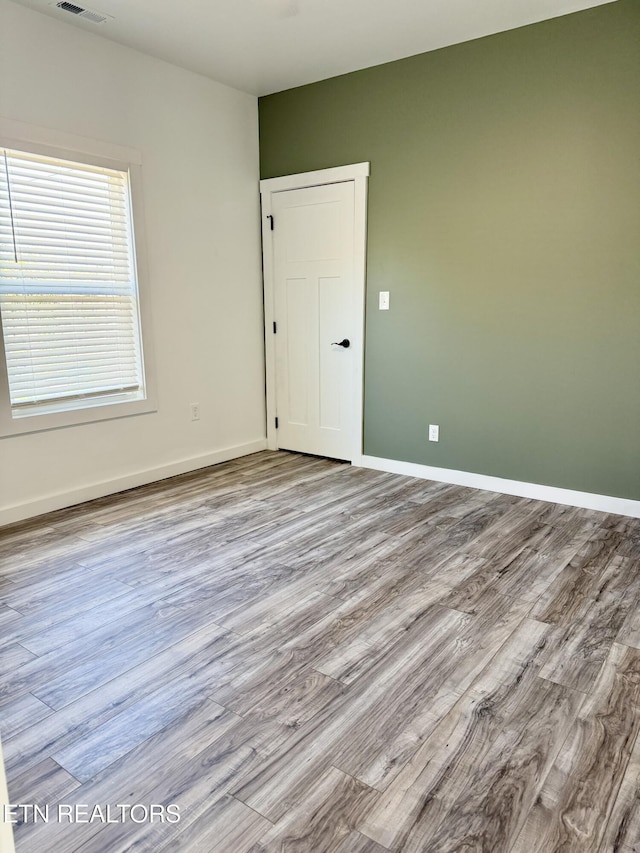 spare room featuring light wood-type flooring