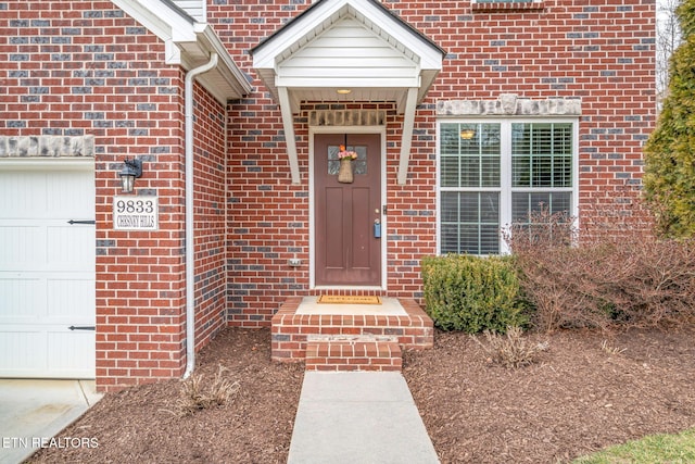 view of exterior entry featuring a garage