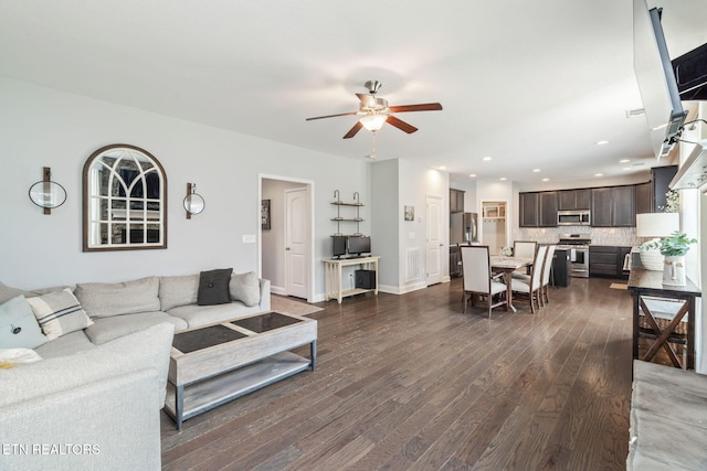 living room with dark hardwood / wood-style floors and ceiling fan