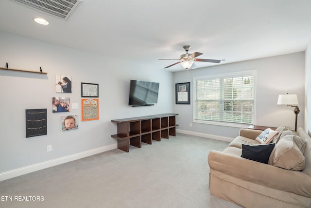 carpeted living room featuring ceiling fan