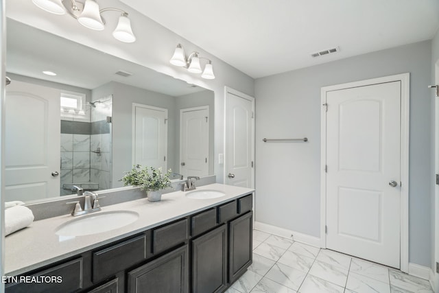 bathroom featuring vanity and a shower with door