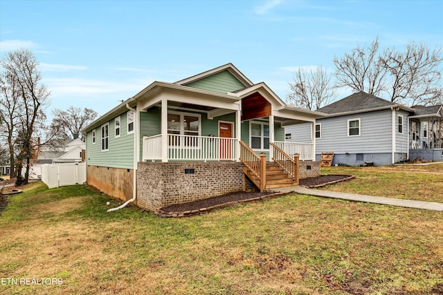 bungalow featuring a front lawn and covered porch