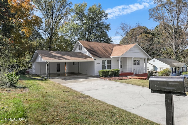 view of front of property with a porch, a carport, and a front yard