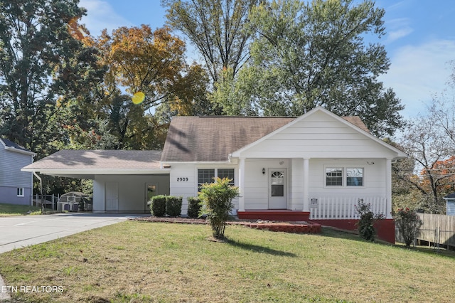 ranch-style home with a carport and a front yard