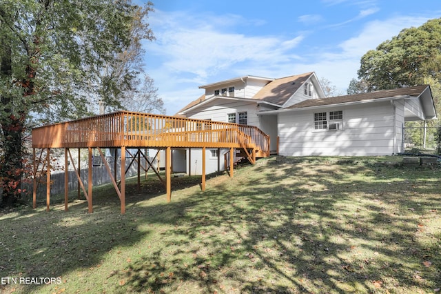 back of property with a wooden deck and a yard