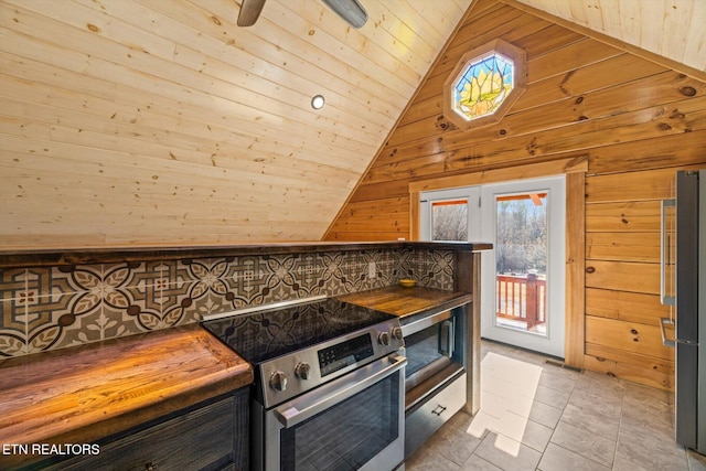 kitchen with appliances with stainless steel finishes, lofted ceiling, wooden walls, and wood ceiling