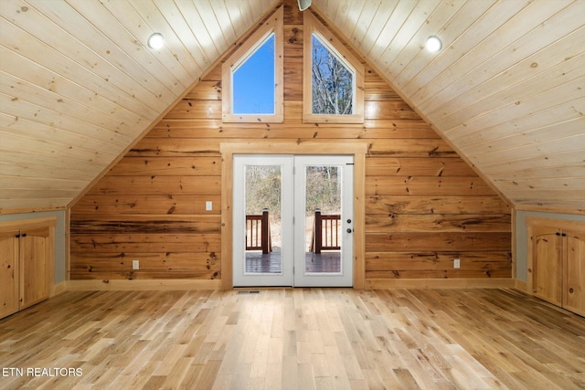 bonus room featuring lofted ceiling, wooden walls, and wood ceiling