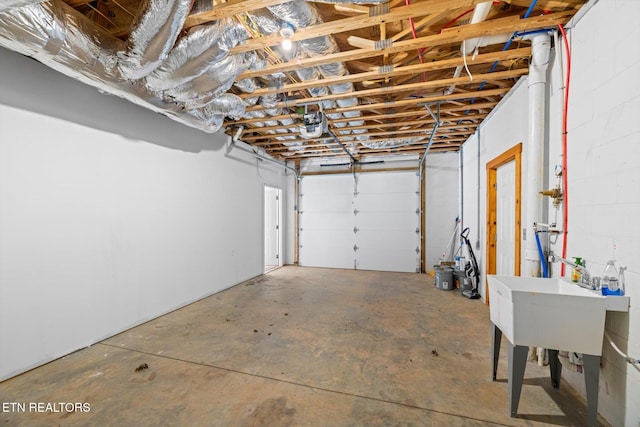 garage featuring a garage door opener and sink