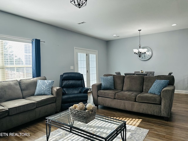 living room featuring dark hardwood / wood-style floors and a notable chandelier