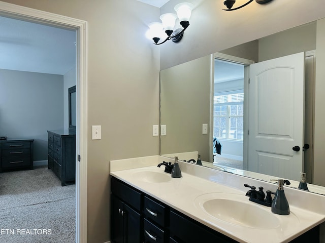 bathroom featuring a chandelier, a sink, and double vanity