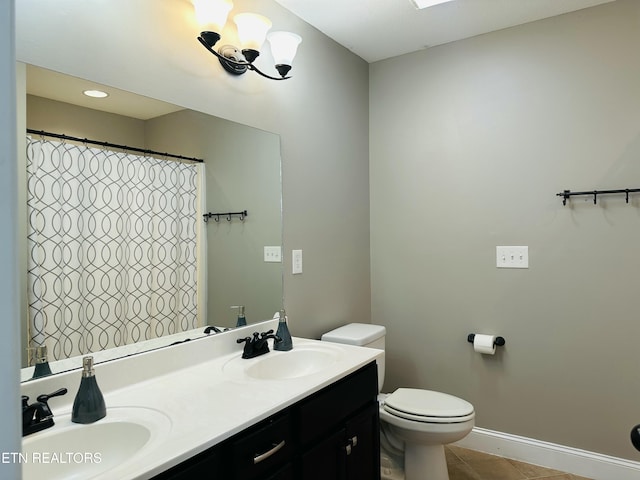 full bath with double vanity, tile patterned flooring, toilet, and a sink