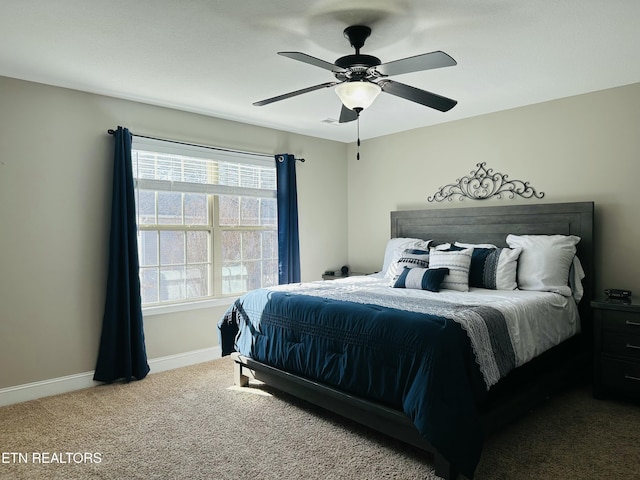 bedroom with carpet floors, a ceiling fan, and baseboards