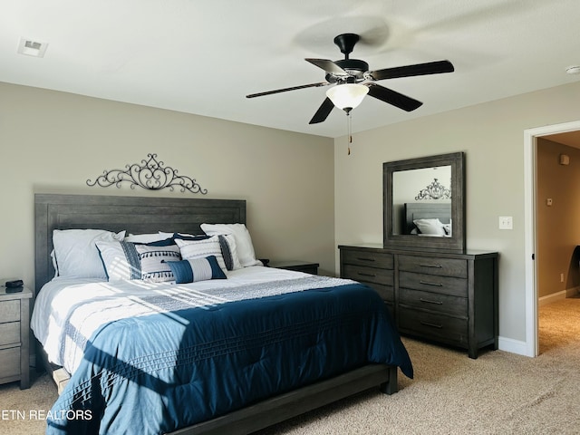 bedroom featuring a ceiling fan, light carpet, visible vents, and baseboards