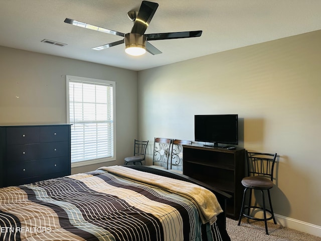 bedroom featuring baseboards, ceiling fan, visible vents, and light colored carpet