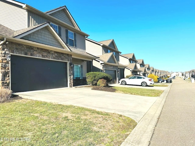 view of front of house with a residential view, stone siding, driveway, and a front lawn