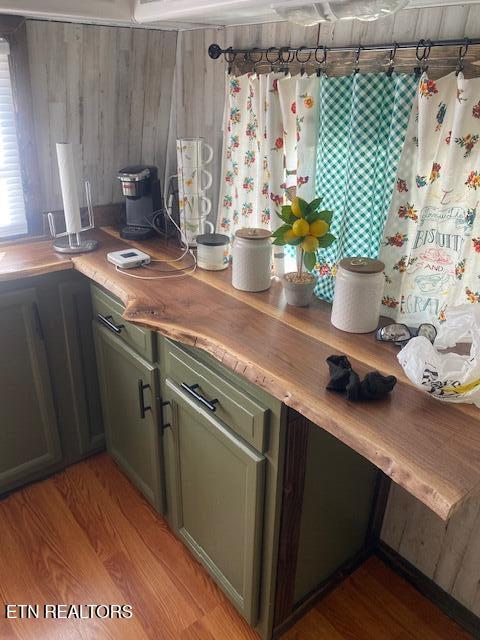 kitchen featuring wood counters, green cabinetry, and light wood-type flooring