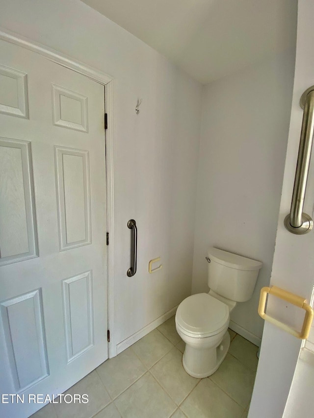 bathroom featuring tile patterned floors and toilet