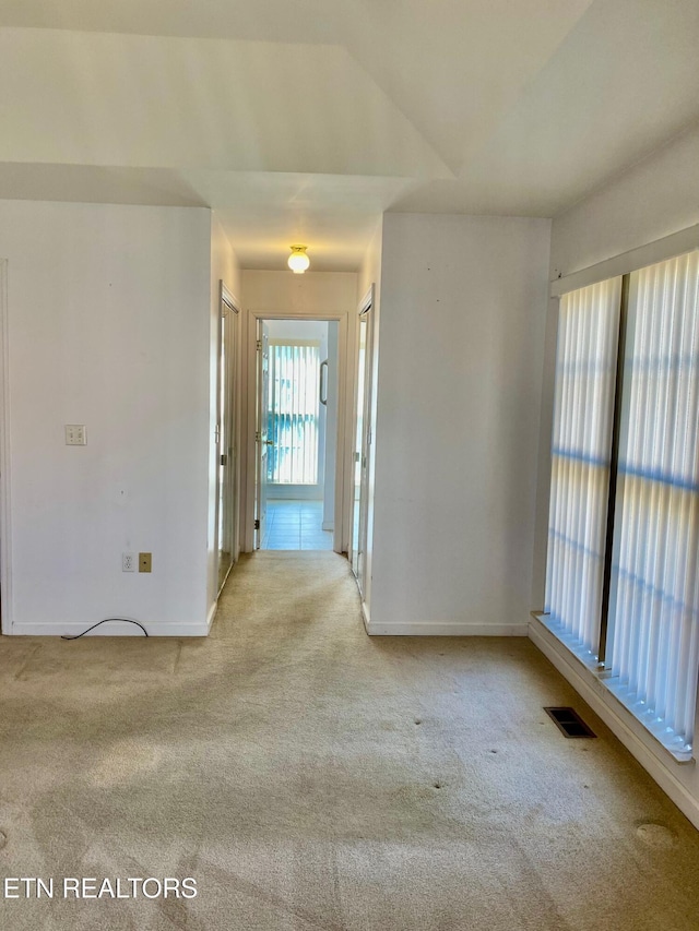 empty room featuring light carpet