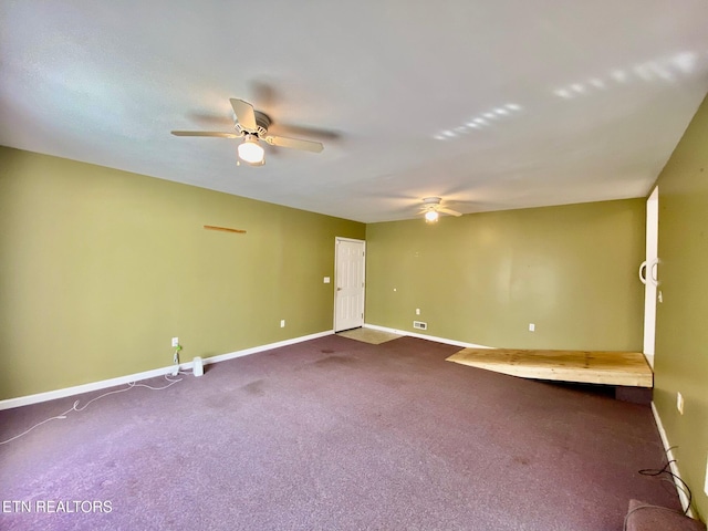 spare room featuring carpet and ceiling fan