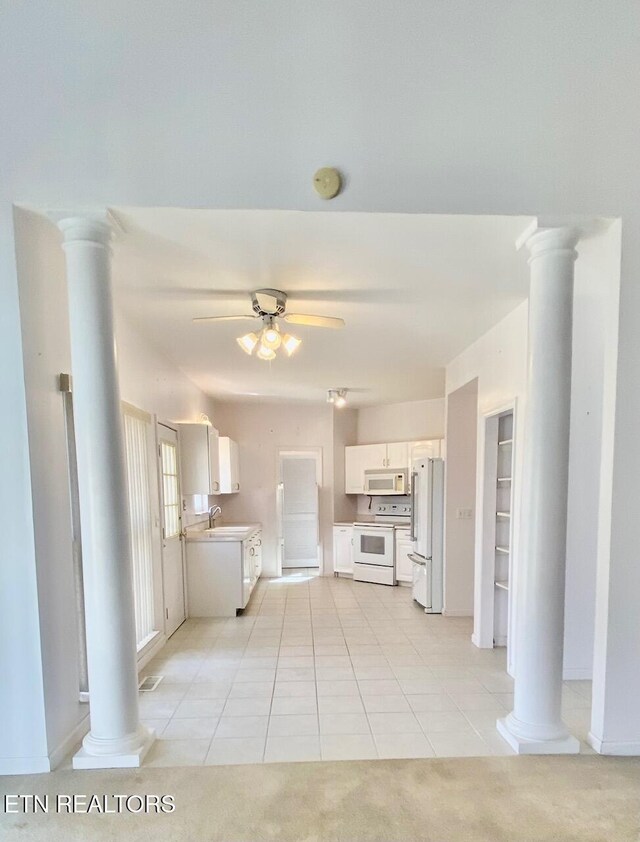 kitchen with white cabinetry, white appliances, decorative columns, and ceiling fan