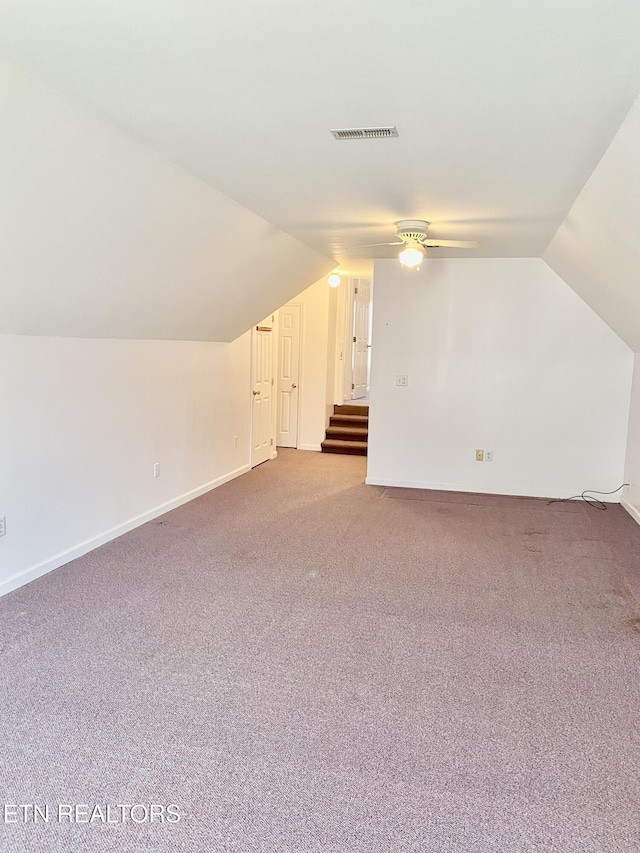 additional living space with lofted ceiling, carpet flooring, and ceiling fan