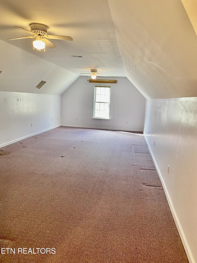 additional living space featuring lofted ceiling, carpet floors, and ceiling fan