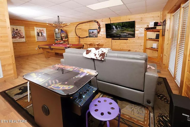 playroom featuring wooden walls, pool table, and light hardwood / wood-style floors