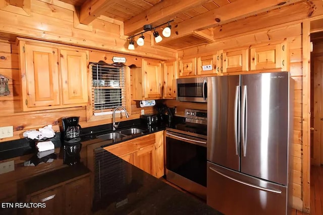 kitchen featuring sink, wood ceiling, light brown cabinets, appliances with stainless steel finishes, and beam ceiling