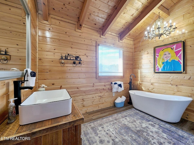 bathroom with a washtub, wood-type flooring, lofted ceiling with beams, wooden ceiling, and wood walls