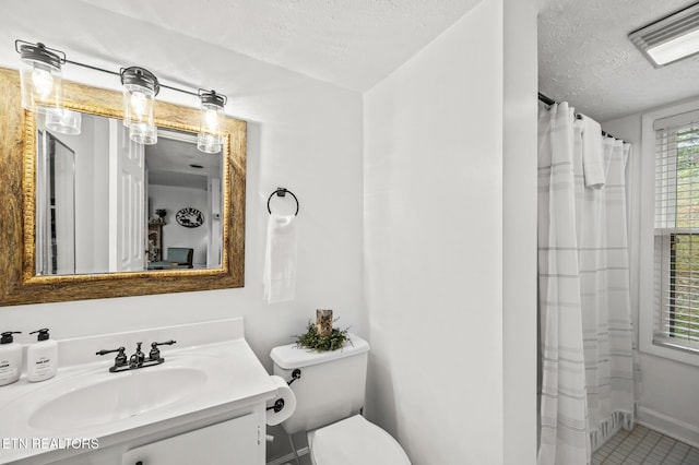 bathroom with vanity, toilet, and a textured ceiling