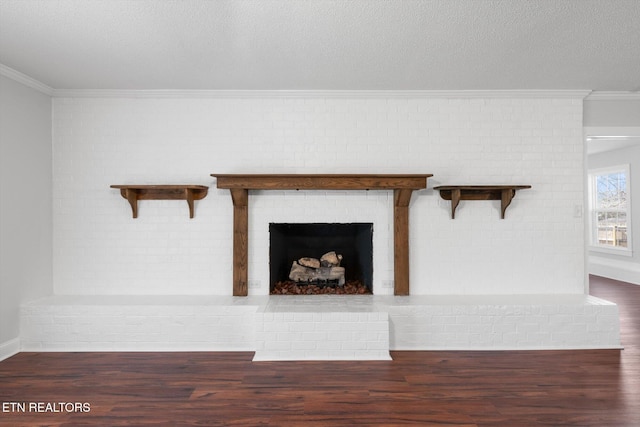 interior details with hardwood / wood-style floors, crown molding, a textured ceiling, and a brick fireplace