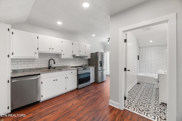 kitchen featuring sink, tasteful backsplash, dark hardwood / wood-style flooring, stainless steel appliances, and white cabinets