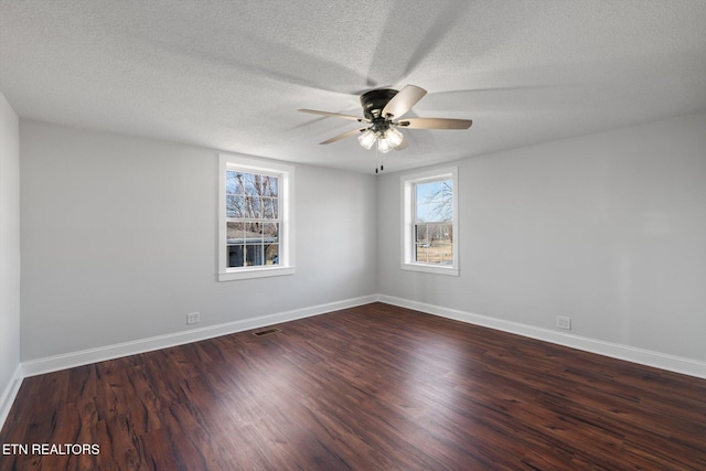 empty room featuring ceiling fan, dark hardwood / wood-style floors, and a textured ceiling