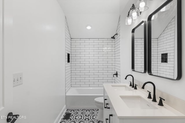 full bathroom featuring tiled shower / bath combo, vanity, tile patterned flooring, and toilet