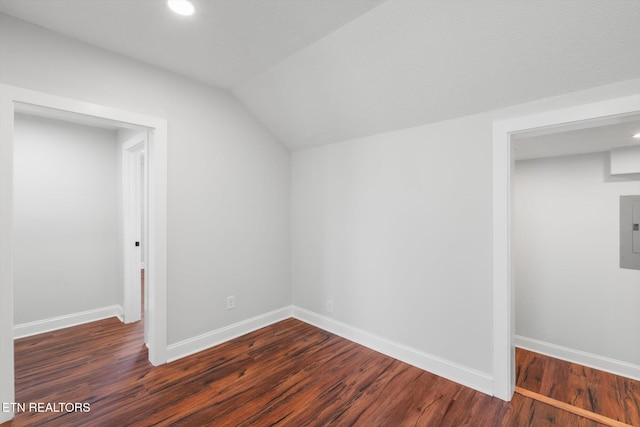 bonus room featuring vaulted ceiling, dark wood-type flooring, and electric panel