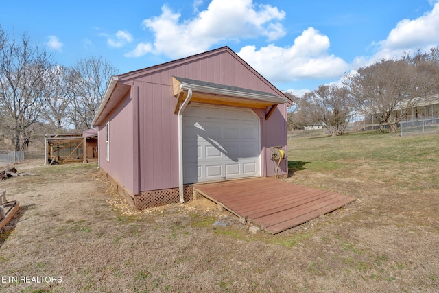 view of outbuilding featuring a garage and a yard