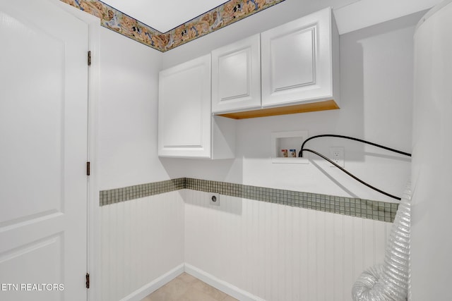 washroom with cabinets, hookup for an electric dryer, and hookup for a washing machine