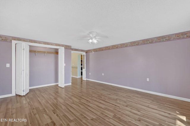 unfurnished bedroom featuring a closet, ceiling fan, and light hardwood / wood-style flooring