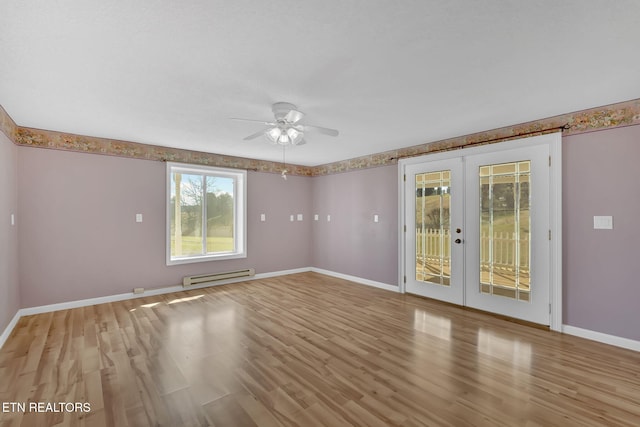 spare room with ceiling fan, light hardwood / wood-style floors, baseboard heating, and french doors